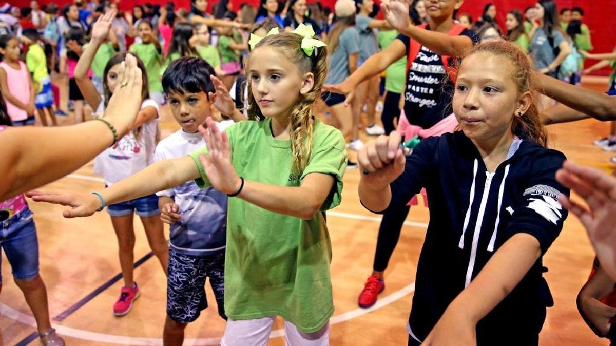 Dahlia Harris 10, (green shirt), does the Zumba dance at summer camp at the Dave and Mary Alper JCC in West Kendall. Nutritionists and fitness experts from Baptist Health South Florida work with the students to get them in shape.