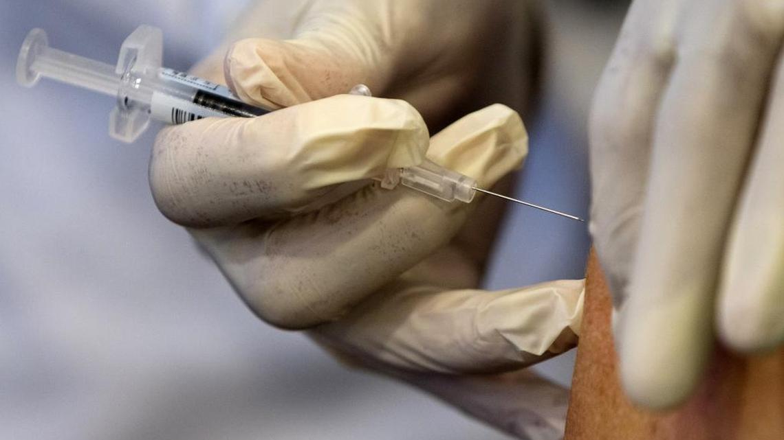 A nurse gives a flu shot in this Sept. 17, 2015, file photo.
