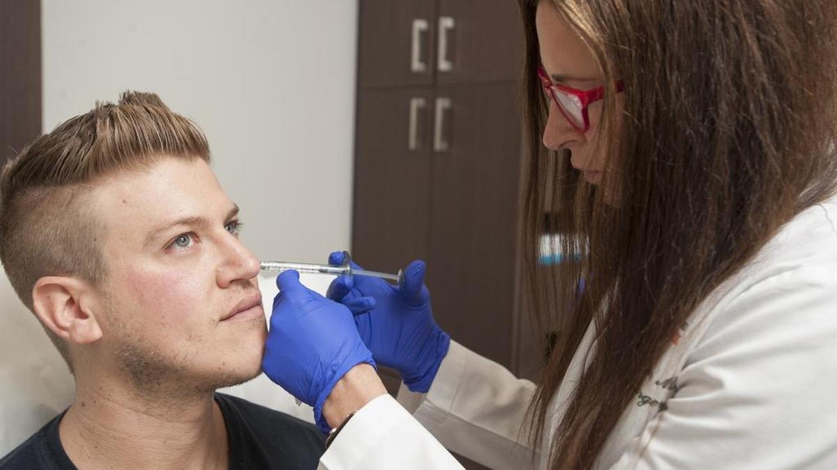 James Provencher, 30, a Miami Beach resident, gets a dermal-filler injection from Dr. Lisa Grunebaum, a plastic surgeon at UHealth — the University of Miami Health System.