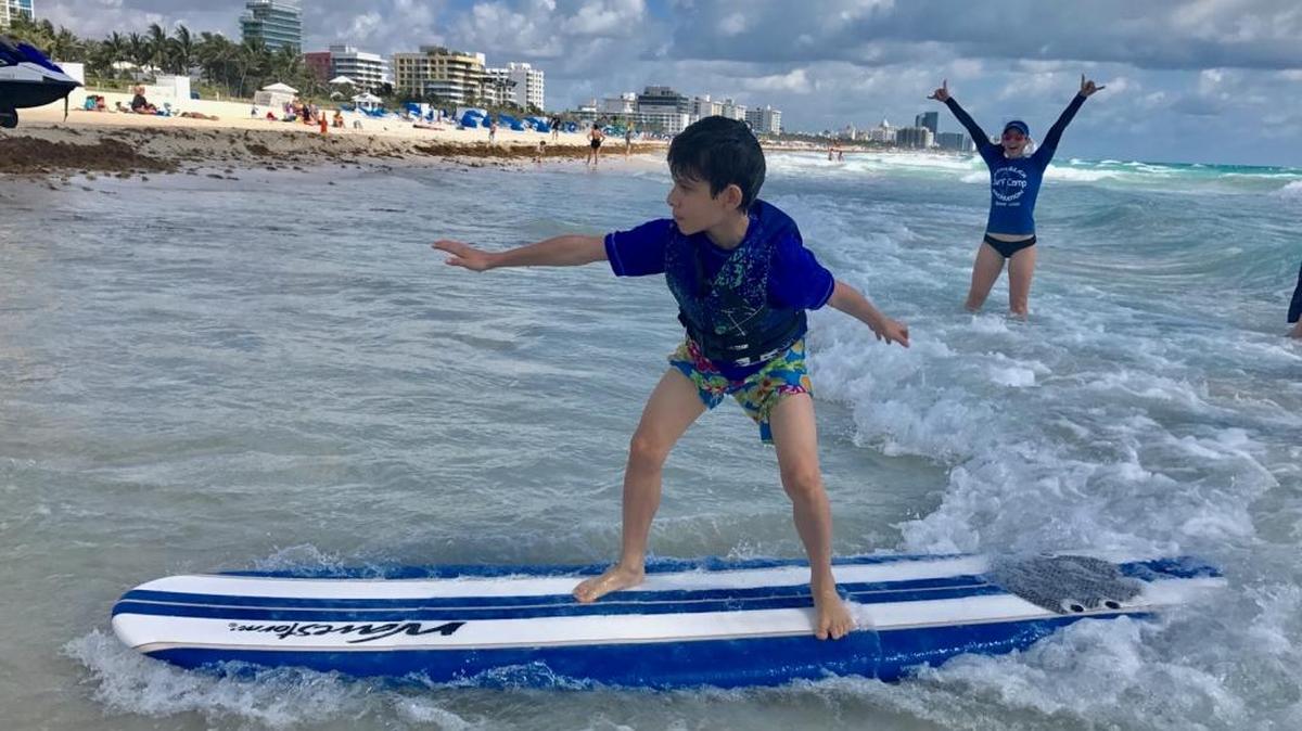 Roberto Richter, 11, enjoys the beach at a surf camp held over spring break for children on the autism spectrum. The camp is sponsored by the University of Miami-NSU Center for Autism and Related Disabilities(UM-NSU CARD) and the Miami Beach Parks Department. The camp was held this year at South Pointe Park and the adjacent beach.