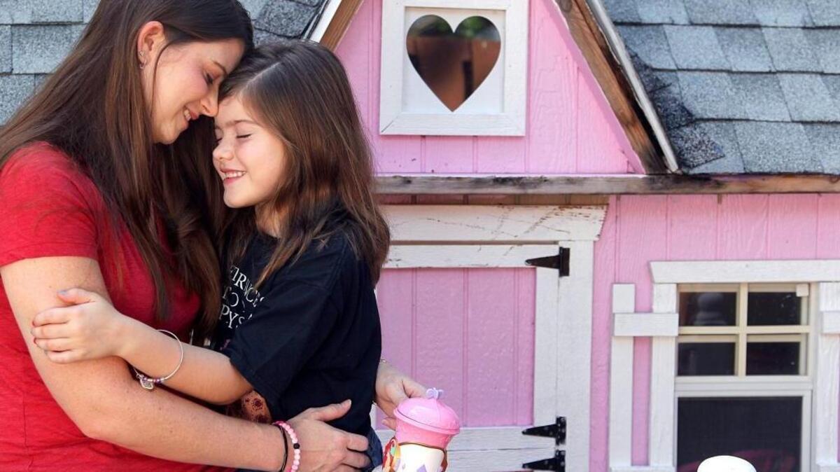 Valerie Bunt, 33, a young breast cancer survivor poses with her daughter, Alyssa, 8, on Sunday, Oct. 8, 2017.
