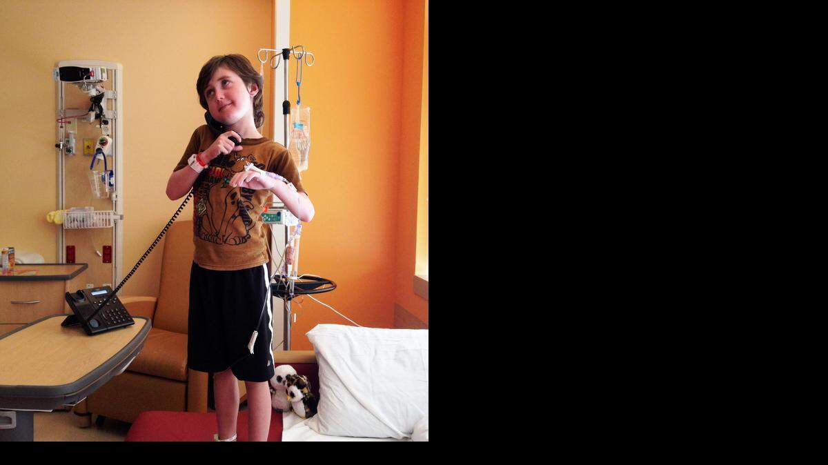 
Timothy Stahlsmith, 9, a patient at Joe DiMaggio Children’s Hospital, calls the contestant line for the live game show ‘Top
3’ on JoeD TV, which is similar to the popular game show ‘Family Feud.’ 

