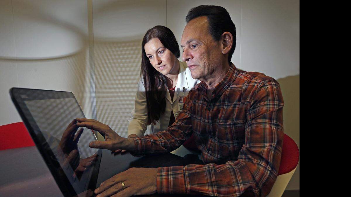 
AT UM CENTER ON AGING: Neuropsychologist Dr. Rosie Curiel, left, is involved in a study of healthy adults ages 63 and older, like Paul Herman, right, to determine if those at risk of Alzheimer’s could be detected before symptoms begin.


