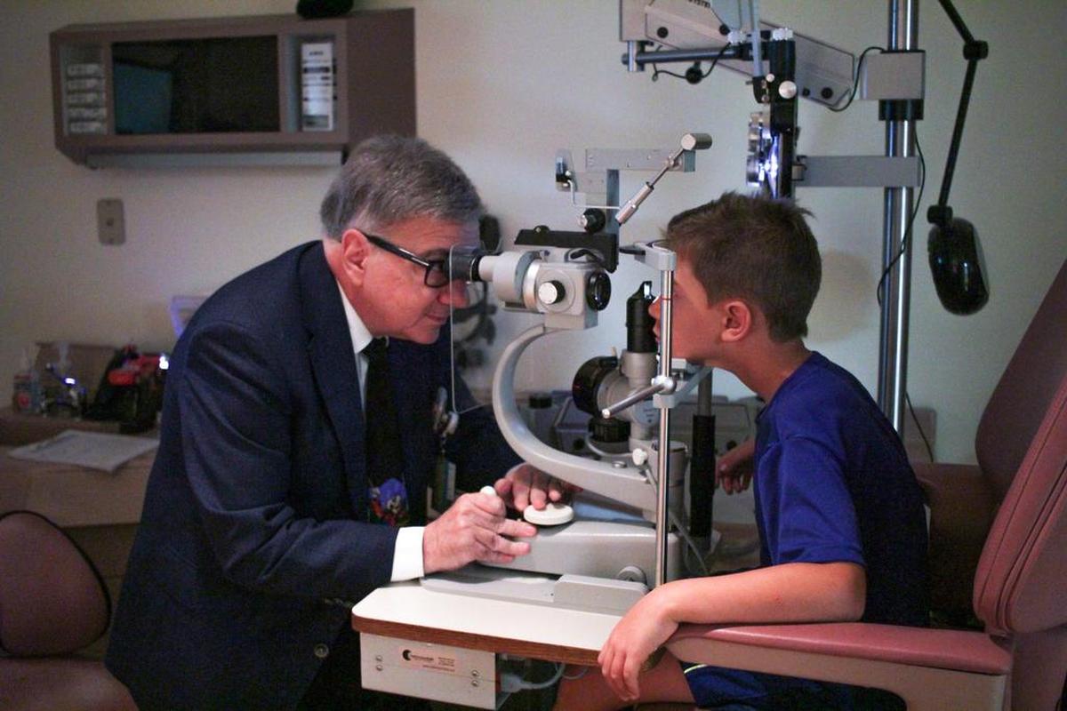 Dr. Roberto Warman, director of pediatric ophthalmology at Nicklaus Children's Hospital, examines his patient, Jordi Salum-Ozcoz.