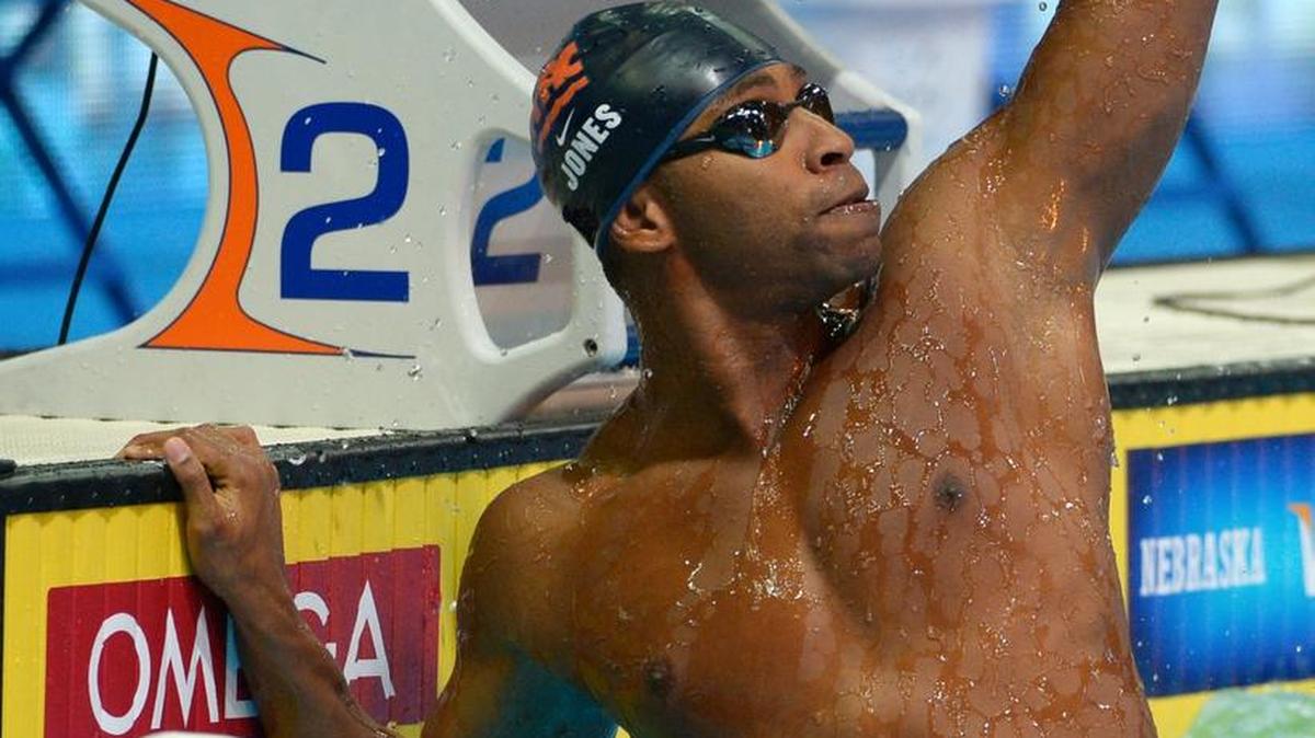 Cullen Jones reacts after winning the men's 100-meter freestyle final at the U.S. Olympic swimming trials, July 1, 2012, in Omaha, Nebraska. At left is Matt Grevers.