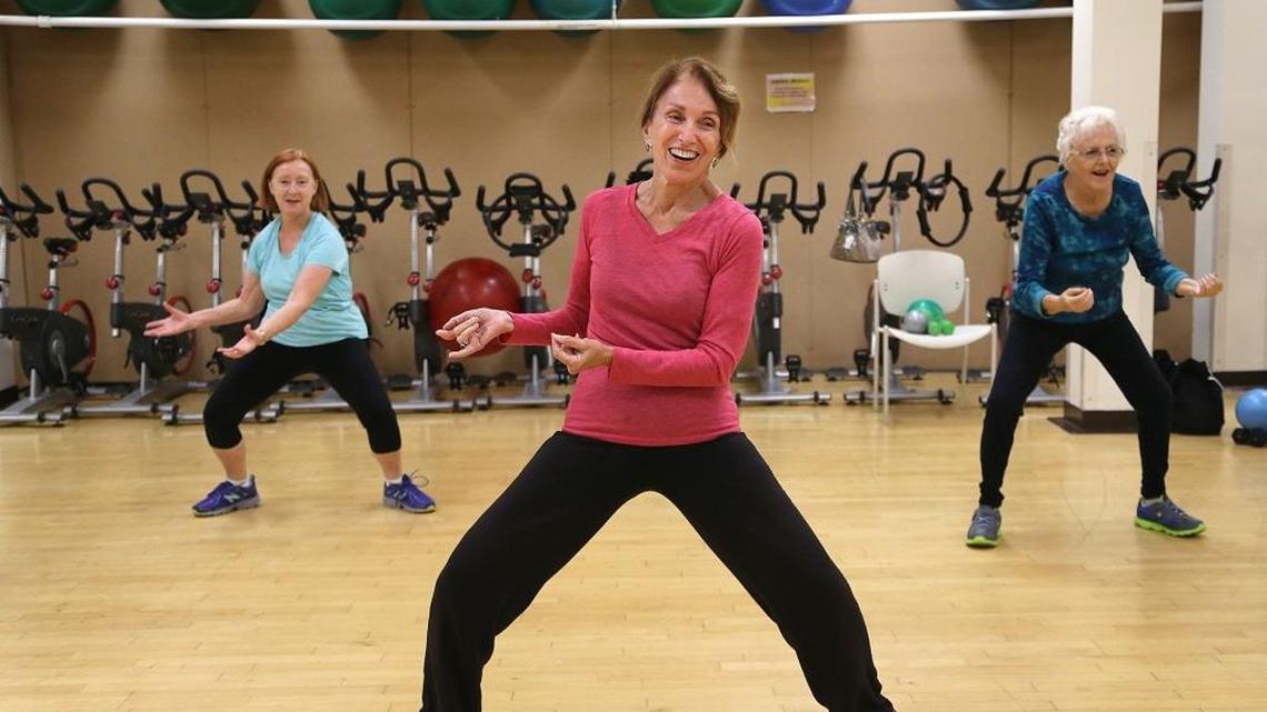 Angela Rhodes, left, cancer survivor Barbara Johns, center, and Lisa Gary, right, follow fitness instructor Jeri Beaucaire in her Morning Motion class at the Fitness Center at Hollywood Memorial.