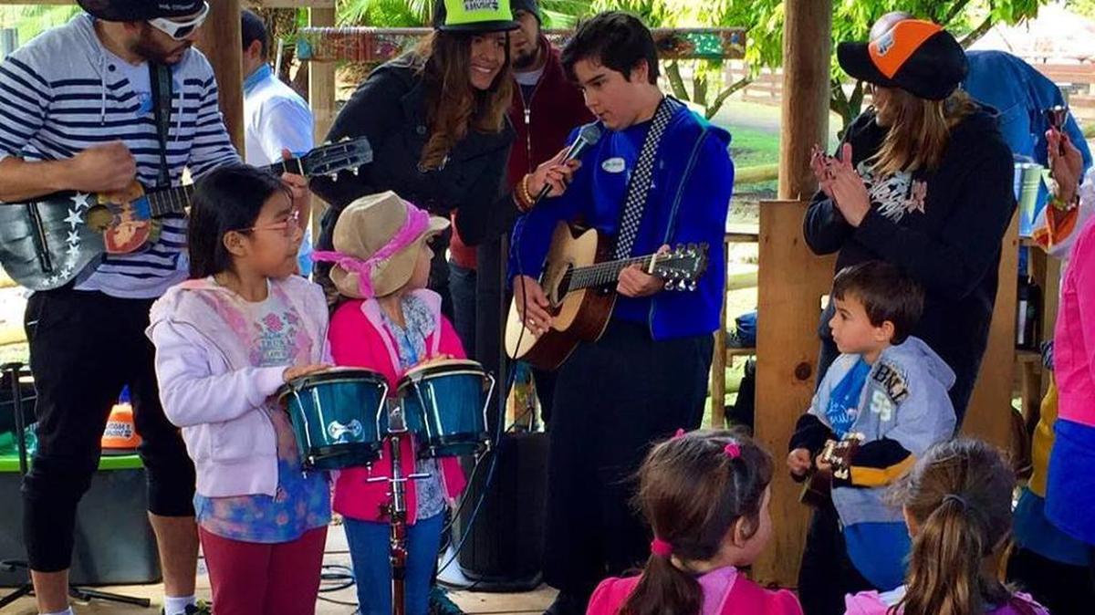 Patricia Kayser, center, during a musical event with several children.