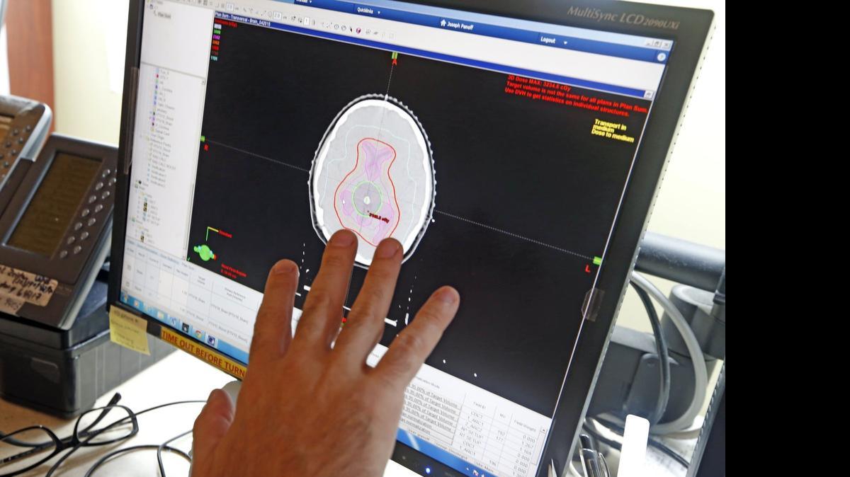 
Dr Joseph Panoff reviews an image of patient Elizabeth Rodriguez’s brain on a monitor at the Sylvester Comprehensive Cancer Center, July 8, 2015. The center is the only site in South Florida that offers pediatric oncology radiation for patients under age 12.
