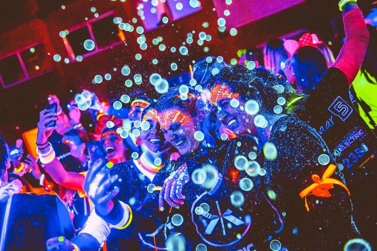 Runners celebrate in an Electric Run 5K. On Saturday, July 8, participants in the Electric Run MLB All-Star 5K will race through Bayfront Park.