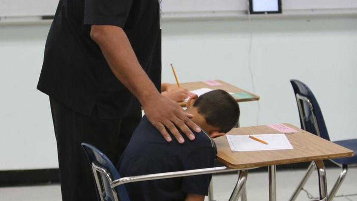 Teacher Herbert McArthur, Jr. gives a little extra encouragement to a student during a special summer camp for children with ADHD run by Floriday International University.At FIU, researchers have been working with Miami-Dade County Schools to come up with the best ways to accomodate students with ADHD in the classroom.