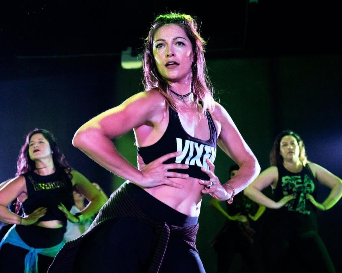 Instructor Celina Beach, front, leads a class through a high energy choreography at Vixen Studios in Wynwood as students Gabrielle Rodriguez, left, and Alexandria Trias, right, dance right along with her.