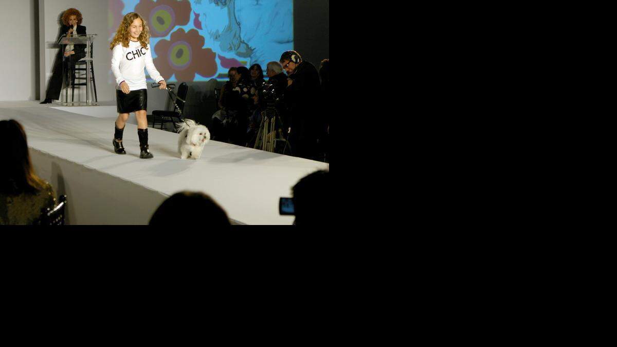 
Gabriella Chariff walks a Maltese down the catwalk during Pawpurrazzi the Humane Society of Greater Miami Adopt-A-Pet annual evening fundraiser at Jungle Island in 2009.
