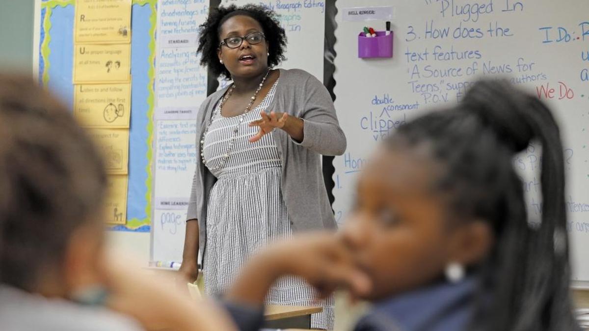 Attorney Maisha Champagne and members of the Gwen S. Cherry Black Women Lawyer Association mentor and visit with fifth-grade girls at Lillie C. Evans K-8 Center.