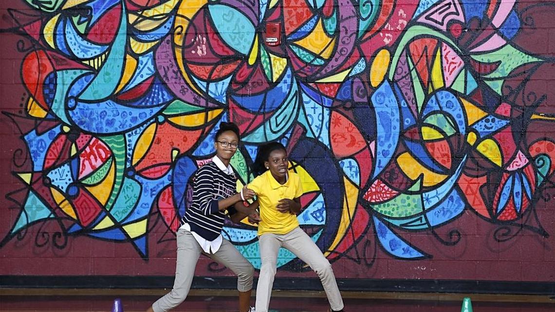 Eighth grader Samiyah Stanley tries to prevent seventh grader Junique Huggins from passing her during a fierce game of "extreme kickball."