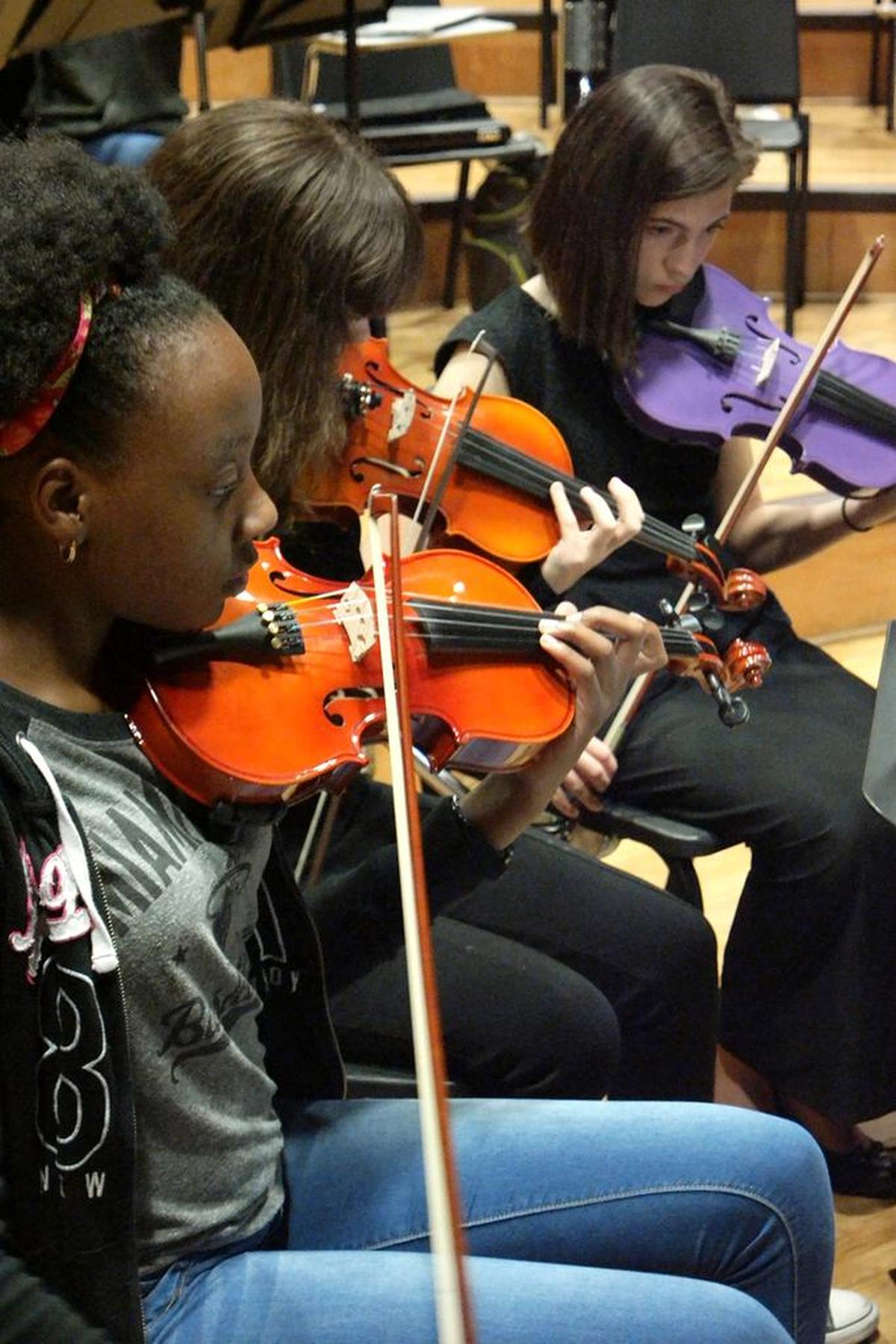 Fadhina Petit Clair, Isabella Perdomo and Justine Padron practice for the South Florida Youth Symphony at Miami Dade College, North Campus.