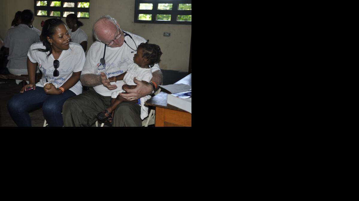 
Dr. Hughes Pettigrew, a Miami pediatrician, examines a baby with help from Marilyn Rousseau, a volunteer interpreter who lives in Davie, during the Man Dodo Humanitarian Foundation medical clinic in 2013 in the southern Haiti rural village of Picot.
