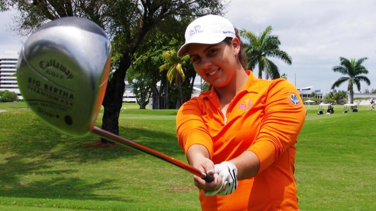 Chanel Gonzalez, a recipient of a golf scholarship thanks to The First Tee and the Orange Bowl Committee, practices her swing.