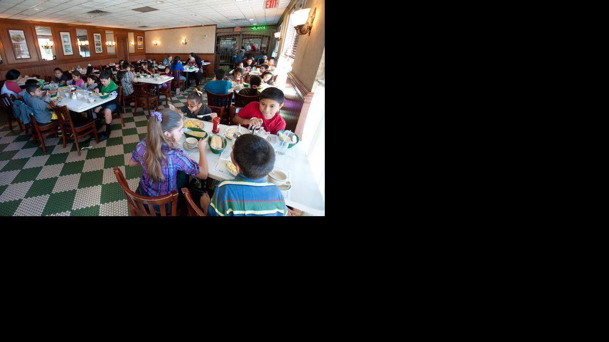 
Kids attend Cafecito Entre Padres, or coffee among parents, breakfast at Versailles restaurant on Saturday, Oct. 25, 2014. 
