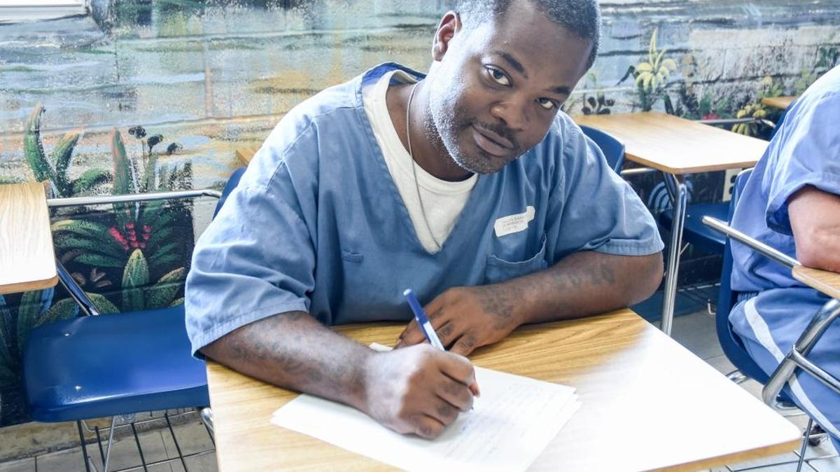 Inmate Samuel Fagin works on an assignment during an Exchange for Change creative writing class at Dade Correctional Institution.