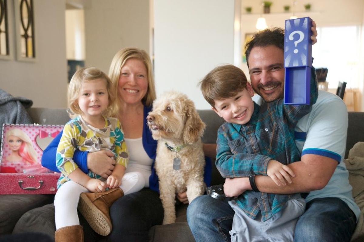 Grady Levine, 7, does magic tricks for his sister, Annie Bea; mom, Nicole; Ham Sandwich, the dog, and dad, Jason.