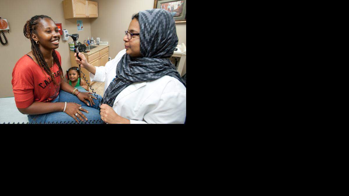 
Hollywood residents Janice McKinson and daughter Jalissa Liebenhaut meet with nurse Husna Oleed at the clinic.


