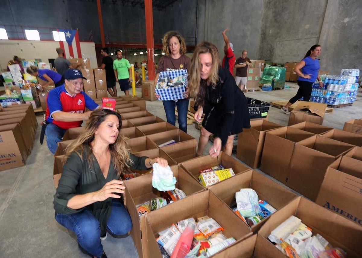 Food Network chef Ingrid Hoffmann, left, alongside volunteers José Noriega, Mariana Marquez and Adriana Vargas Hernandez at the Puerto Rico Relief Committee in Doral. More than 80,000 pounds of goods were collected.