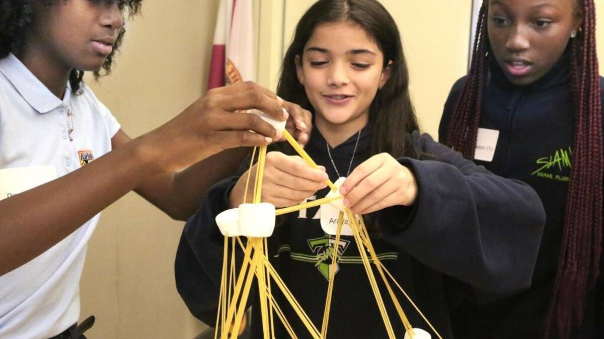 Team Oh Yeah members Dynasia Jean-Charles, left, Araya Lopez, and Dumiya Fenelon, all 12, build a spaghetti-and-marshmallow structure during a tech session Thursday, Oct. 20, 2016 at the University of Miami Life Science & Technology Park in Miami, 1951 NW Seventh Ave. On Thursdays, middle and high school students collaborate with Genius Project partners to explore principles of design and architecture. Araya and Dumiya are in seventh grade at SLAM (Sports Leadership And Management) Charter School. Dynasia is in seventh grade at Aspira Charter School.