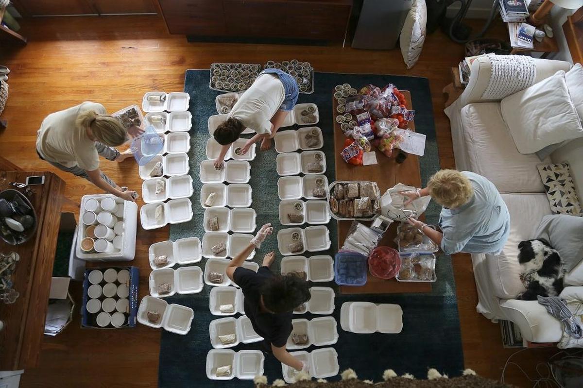 A group of women gather to assemble meals at the home of Margit Bisztray to be distributed to workers, volunteers, and residents rebuilding Big Pine Key on Wednesday, October 25, 2017.
