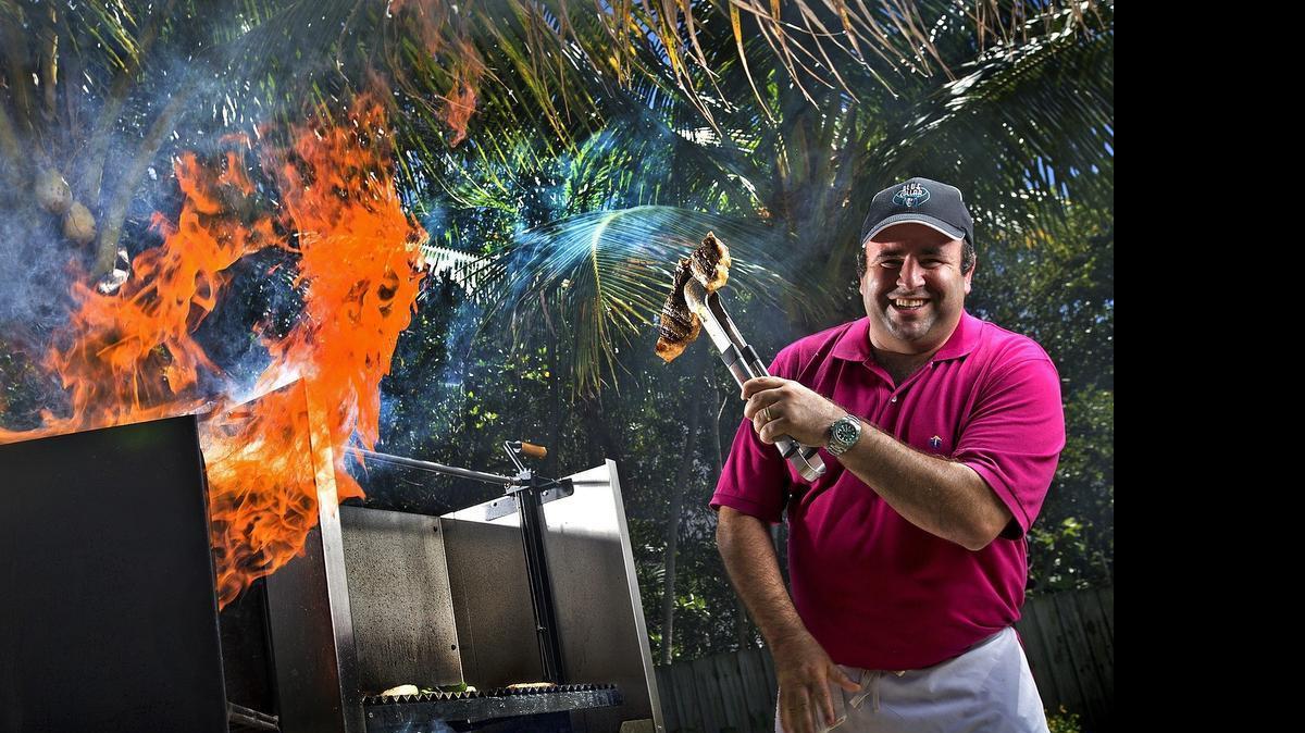 Feel the rush: Chef Danny Serfer mans his impressive backyard barbecue grill on Tuesday.