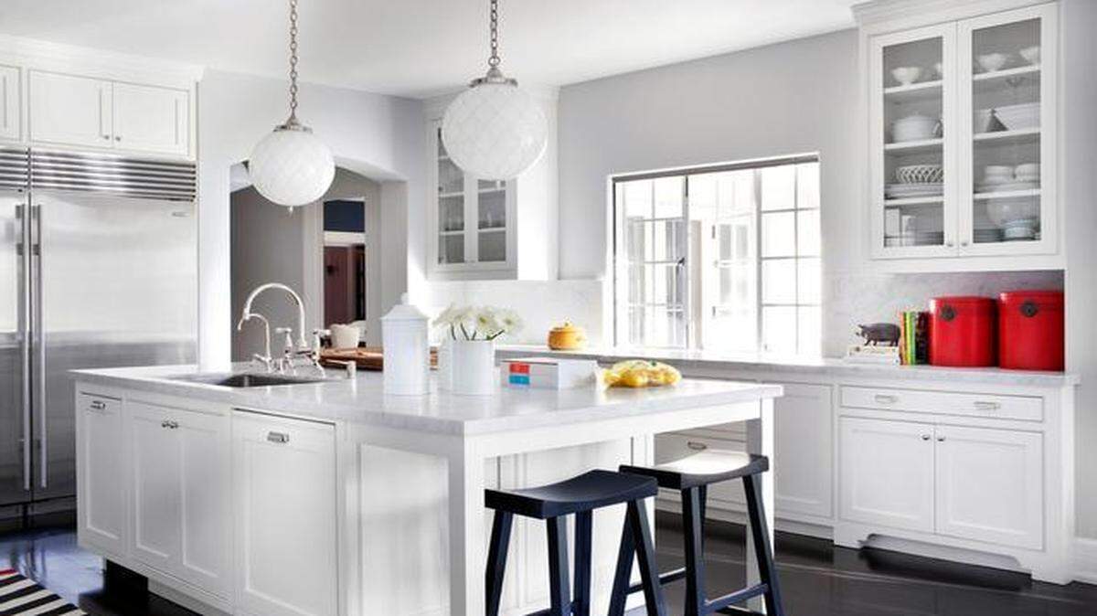
This kitchen has Calacatta marble countertops and backsplash, plus custom Shaker-style cabinetry for both the perimeter cabinets and the center island. 

