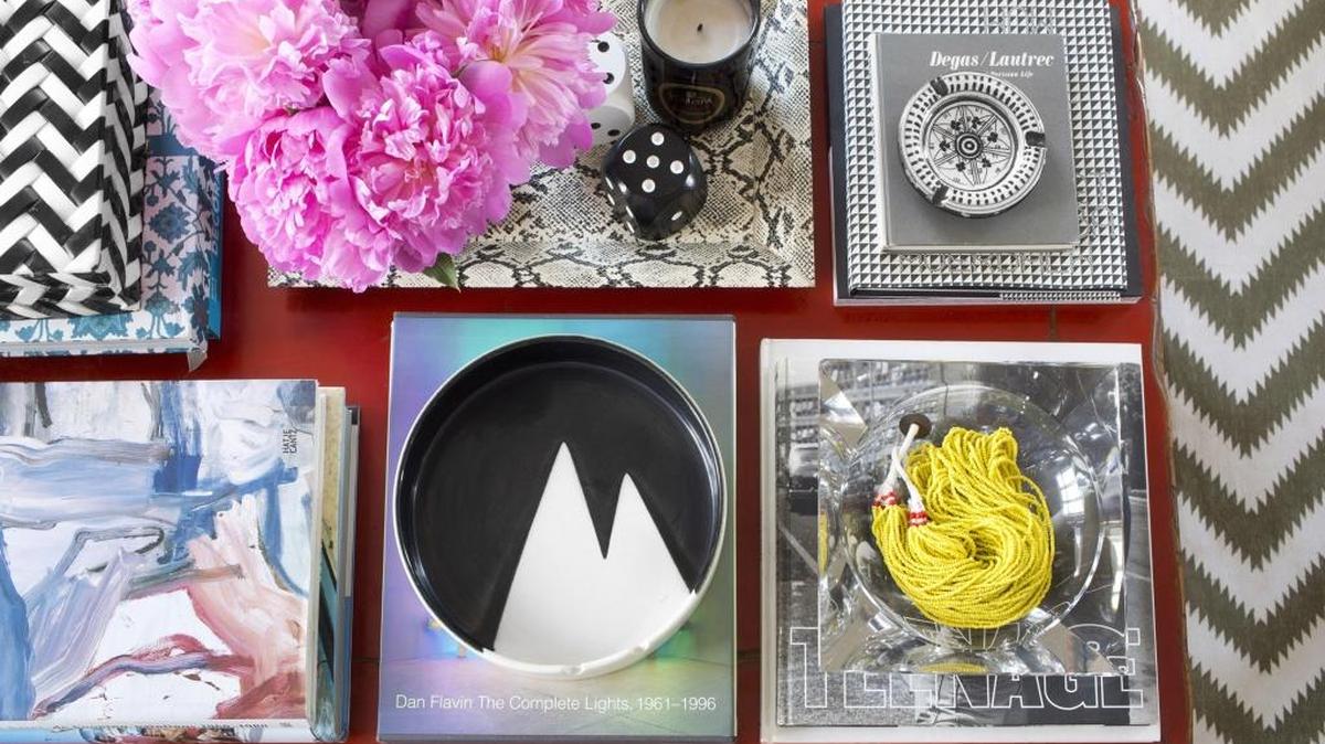 Max Humphrey of Burnham Design in Los Angeles uses decorative trays to corral clutter and bring a sense of organization to this very full, colorful table.