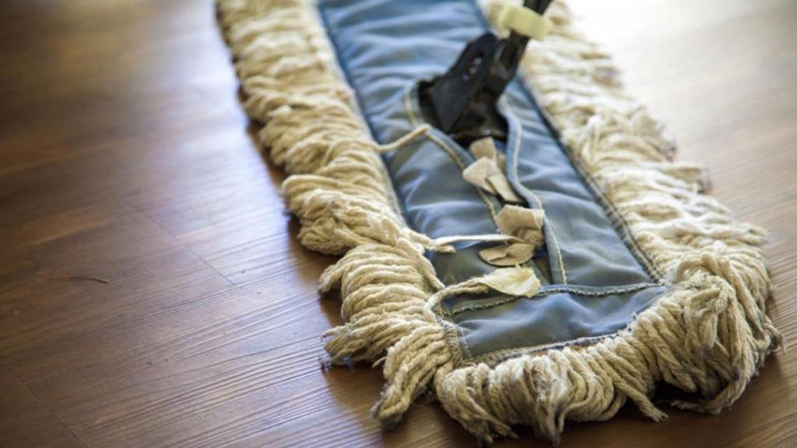 Use a duster or soft vacuum brush attachment to remove dirt and debris before cleaning wood flooring.