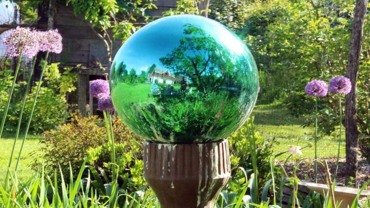 
A green-tinted gazing globe visually takes in all of last summer’s garden in New Paltz, New York. These mirrored glass ornaments fell out of favor about 50 years ago, but are making a comeback.
