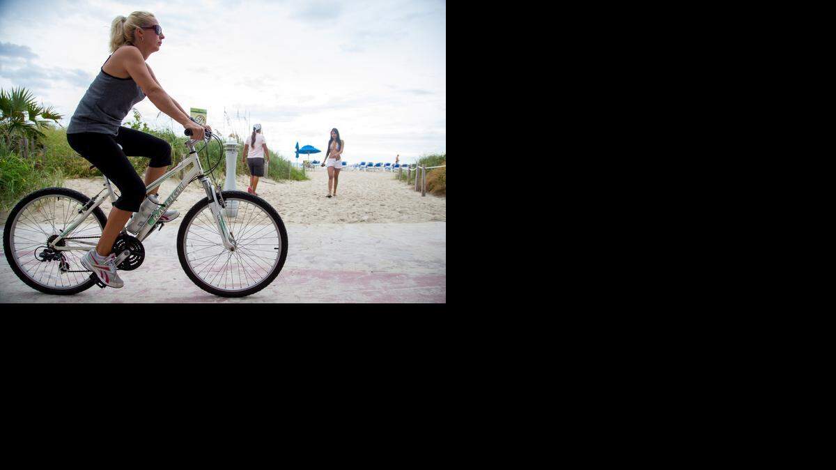 
Where We Live: This is the first installment of an occasional series highlighting various South Florida neighborhoods. Here, a cyclist begins her morning on the North Beach boardwalk near 66th Street. 
