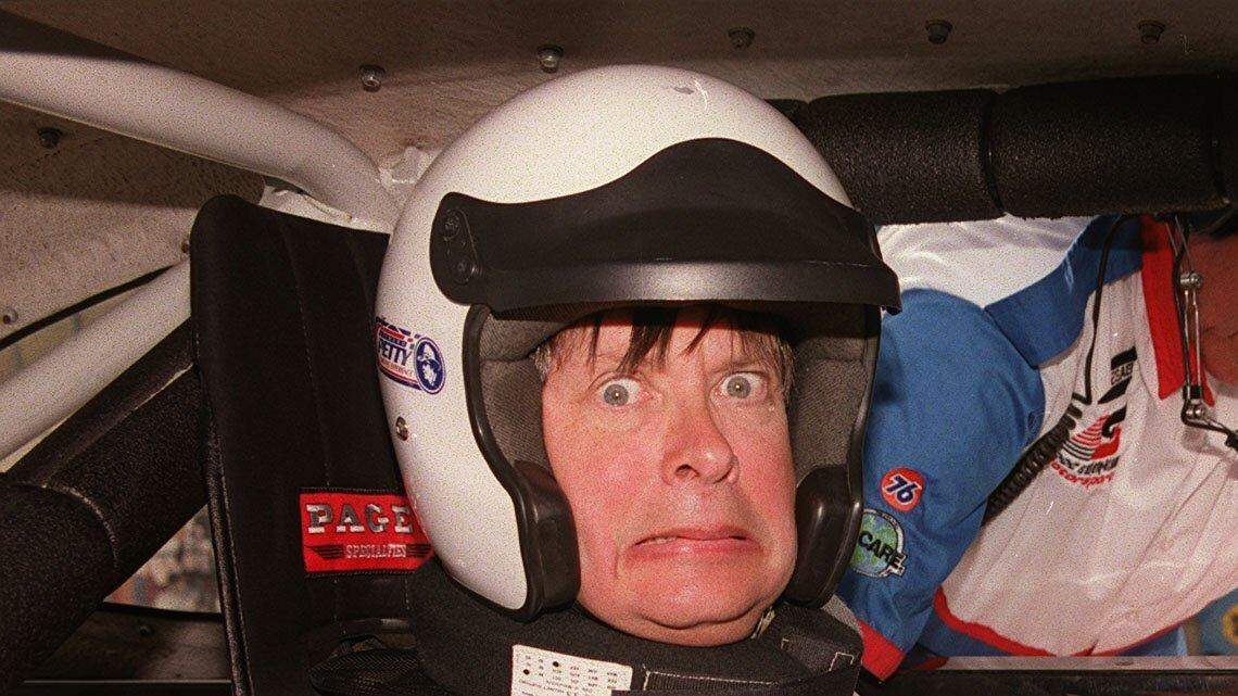 2/18/00; Dave Barry is harnessed into a race car at the Homestead Miami Speedway at the Richard Petty Driving Experience. Barry spent the day learning how to drive and driving at high speeds.
