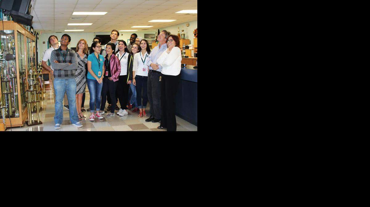
Dave Barry with a group of Coral Reef students and, at far right, the real principal, Adrianne Leal. We’re watching the morning announcements on the school’s close-circuit TV. 
