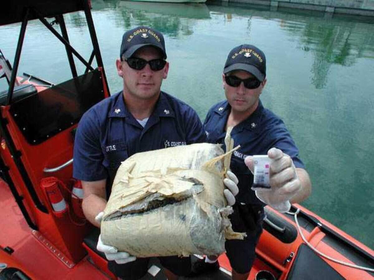Coast Guard officers with a drug test kit and bale of marijuana in Marathon, Florida.