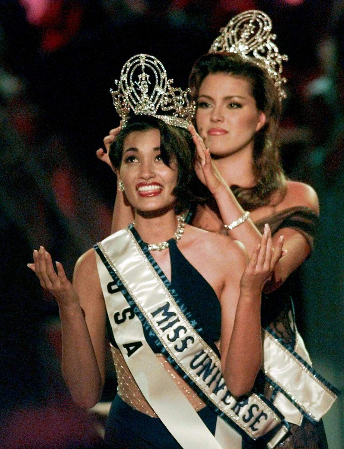 The outgoing Miss Universe, Alicia Machado, places the crown on the head of the new Miss Universe, Brook Mahealani Lee, who looks heavenward as if to say: "Thank you! Now I can eat again!"