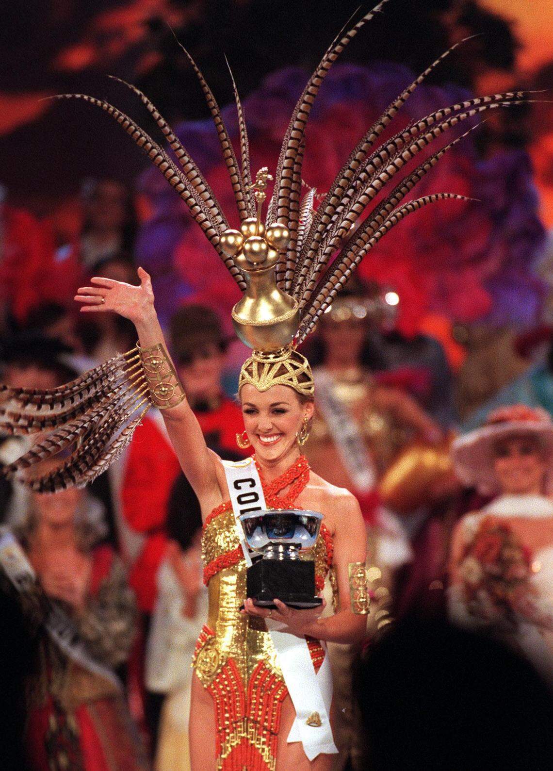Miss Colombia models an authentic and traditional headpiece that iscommonly worn by women who live in houses with enormous door openings.