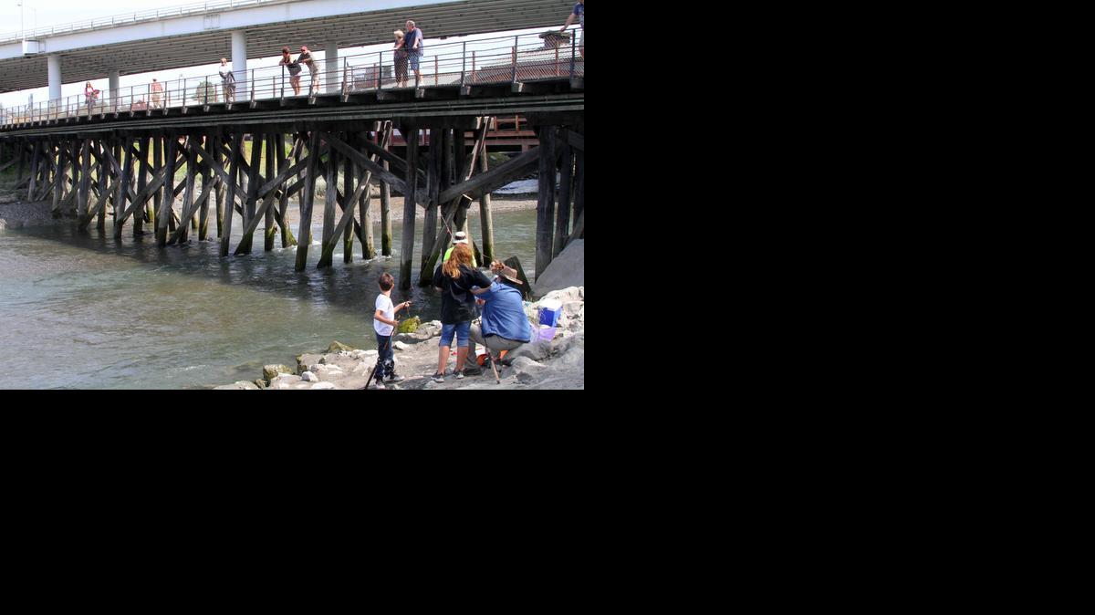 
People watch fishermen angle for salmon on Ship Creek in downtown Anchorage.


