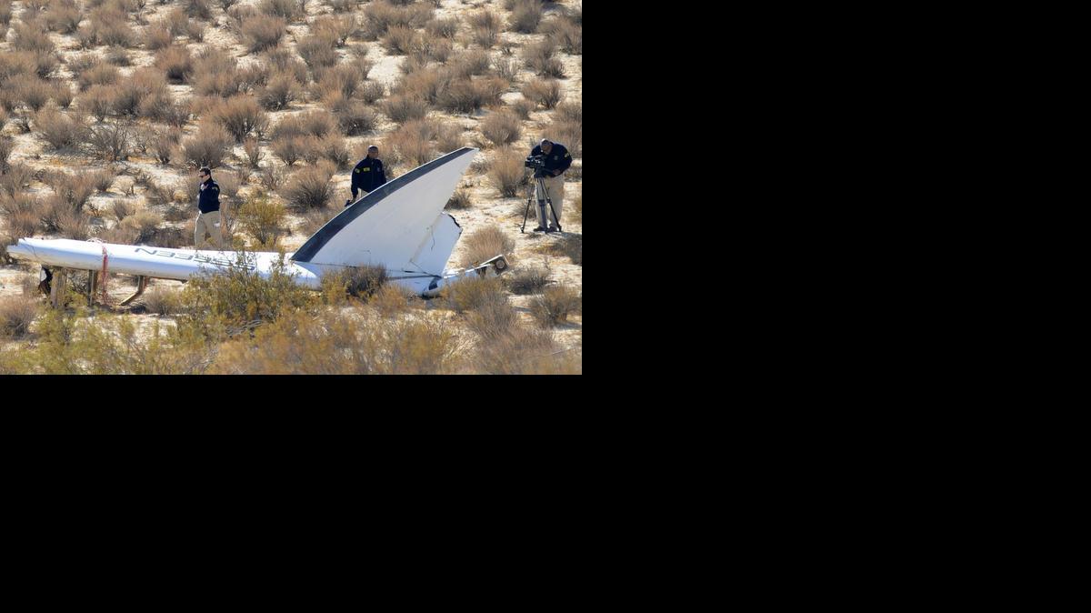 
A National Transportation Safety Board team surveys a tail section from the Virgin Galactic SpaceShipTwo, which crashed on Friday.


