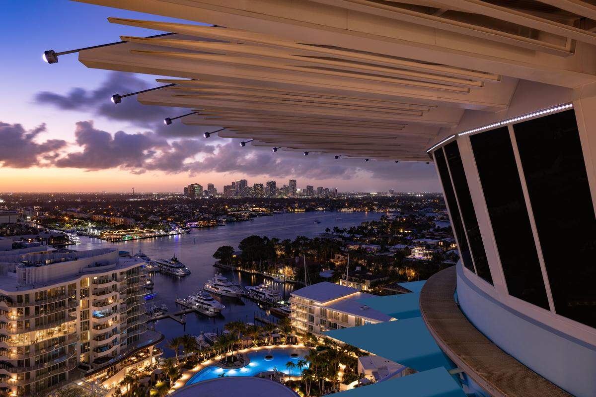 Elevated perspective from the tower, overlooking yachts and the Intracoastal at twilight.