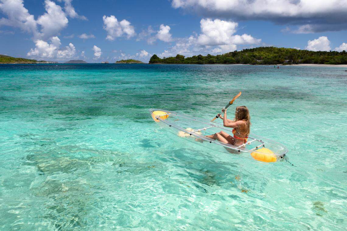 Woman kayaking from a tropical beach, Scott Beach, St. John