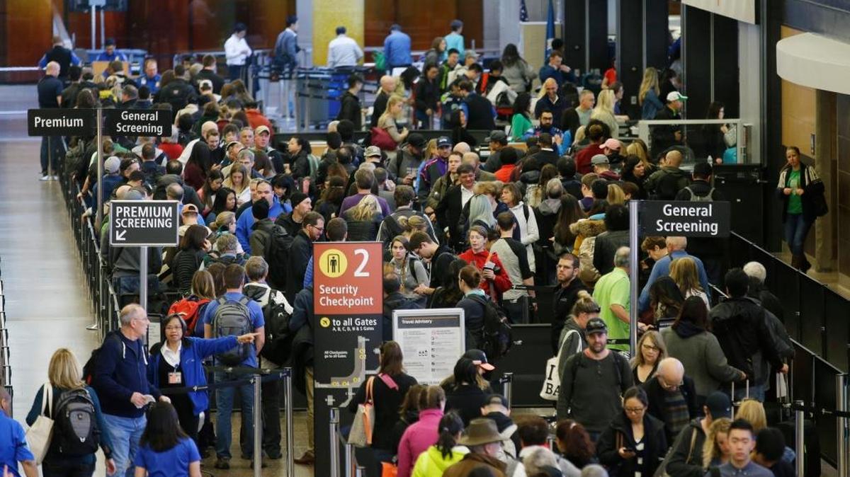 Travelers wait in line for security screening at Seattle-Tacoma International Airport in Seattle last week. Fliers will likely face massive security lines at airports across the country this summer, with airlines already warning passengers to arrive at least two hours early or risk missing their flight.