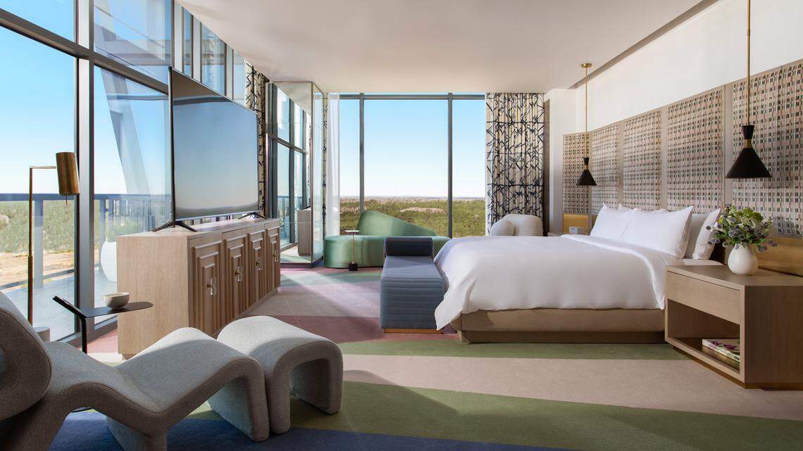 A view of the penthouse master bedroom with floor to ceiling windows and king size bed.