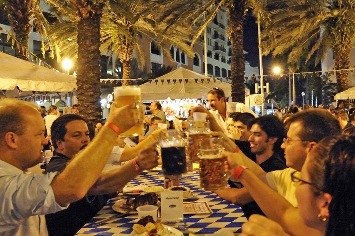 Revelers toast at Fritz and Franz Bierhaus during an earlier Octoberfest in Coral Gables.