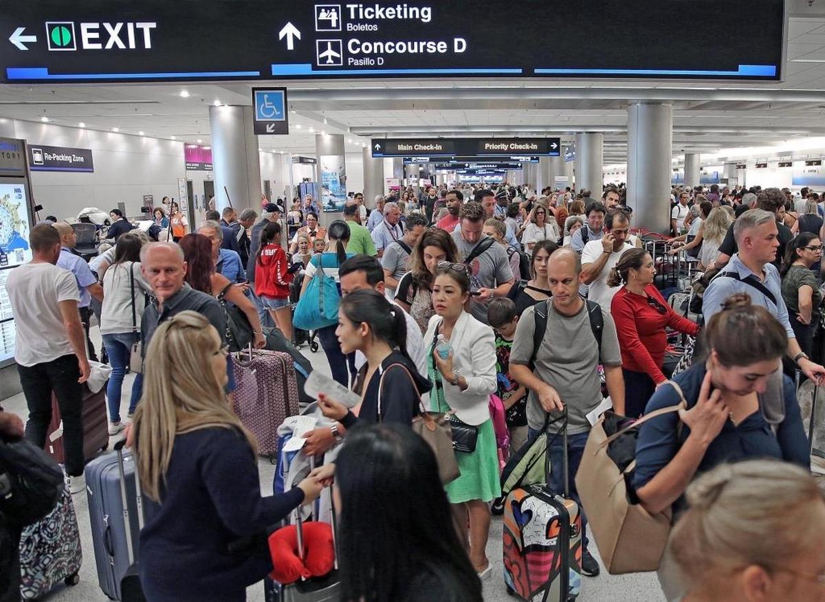 Thousands of travelers pack Miami International Airport as they wait in line to leave Miami on Thursday, September 7, 2017.