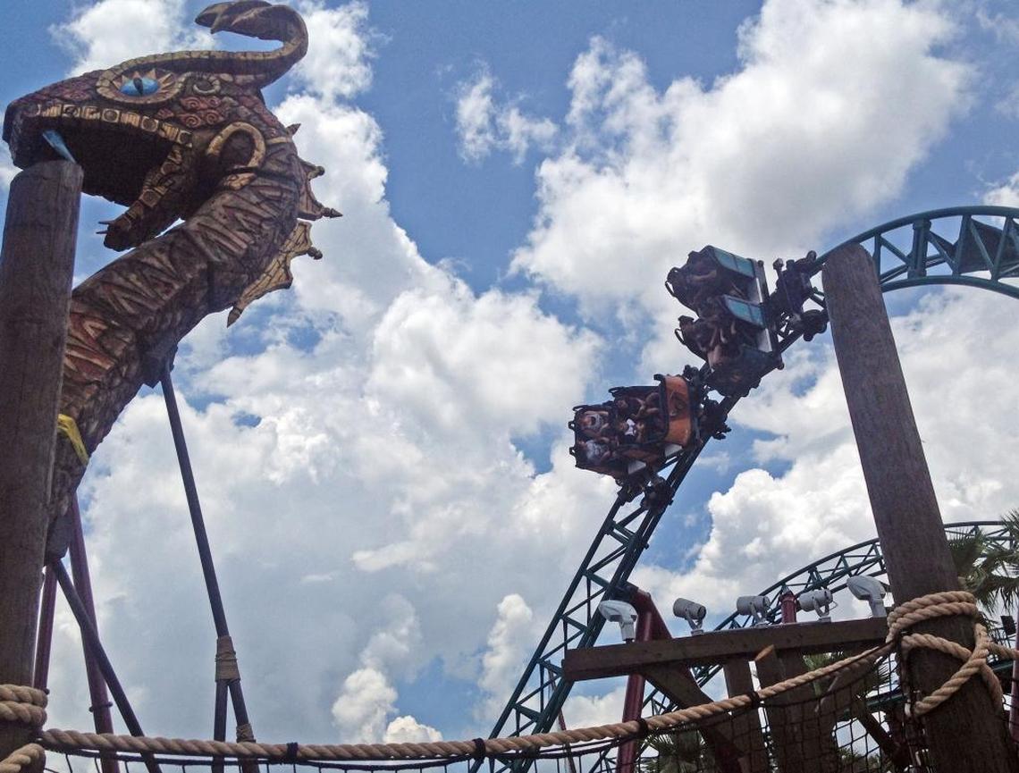 Cars spin on the track of Cobra’s Curse, a roller coaster at Busch Gardens.