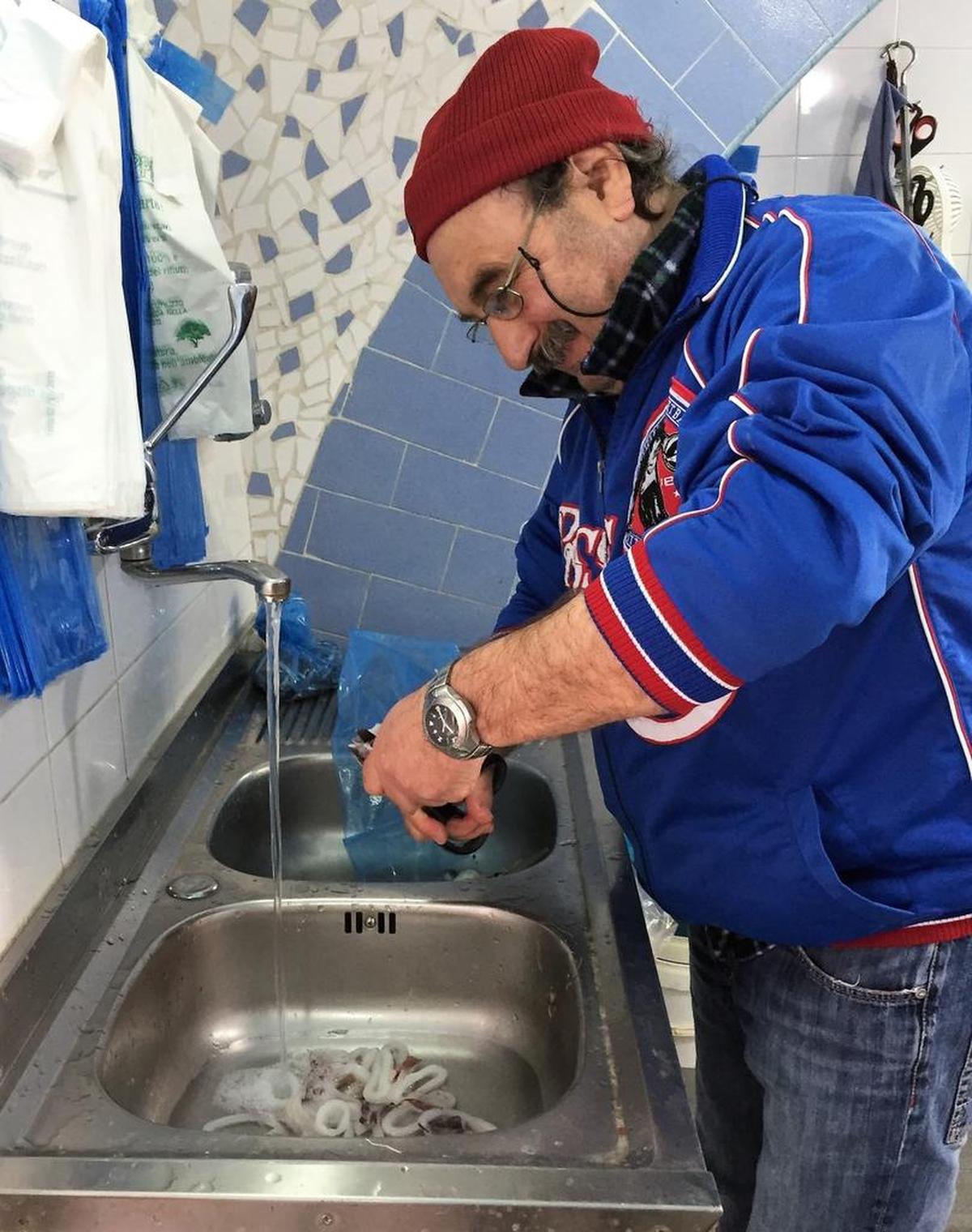 Minori’s fish monger cleans and cuts calamari