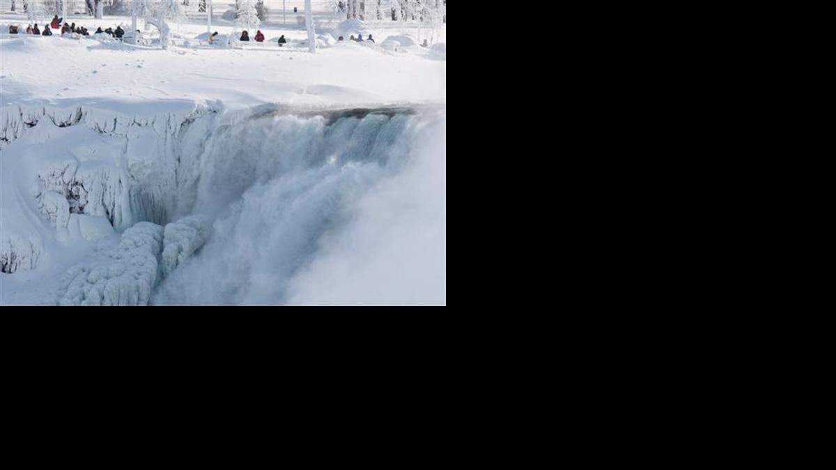 
Niagara Falls State Park visitors look over masses of ice formed around the American Falls, photographed from across the Niagara River in Niagara Falls, Ontario, Canada, Thursday, Feb. 19, 2015. 
